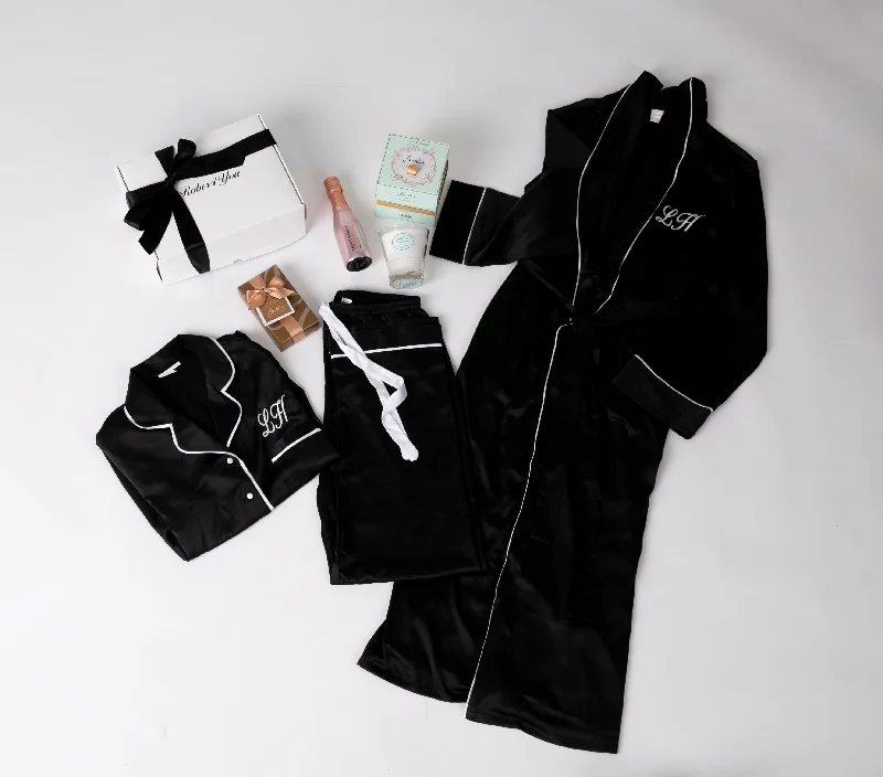 women's pajamas with a cozy, warm feelLong Luxurious Silky feel full lenght black satin robe with piping with Matching Pyjamas with chocolates, champagne, candle all presented in a gift box